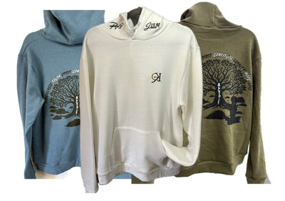 Heather Blue, white and olive green PV hoodies laid flat