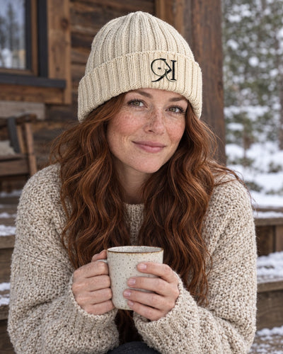 Beige GK beanie worn by a cabin